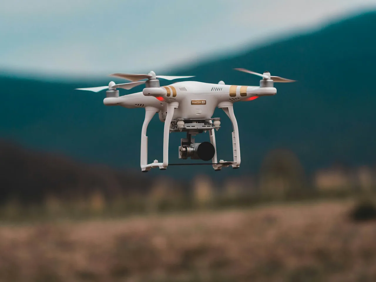 A quadcopter hovering above a landscape
